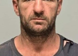 Police descend on remote town after possible sighting of alleged triple murderer Police descend on remote town after possible sighting of alleged triple murderer